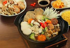 Nồi lẩu nấm rau củ đang sôi cùng đĩa nấm và rau ăn kèm